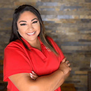 Hidden Valley orthodontics director of smiles journey, Adriana, in red dental scrubs