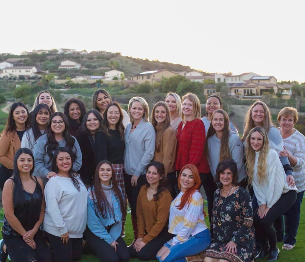 The Hidden Valley Orthodontics team posing for a photo on a golf course.