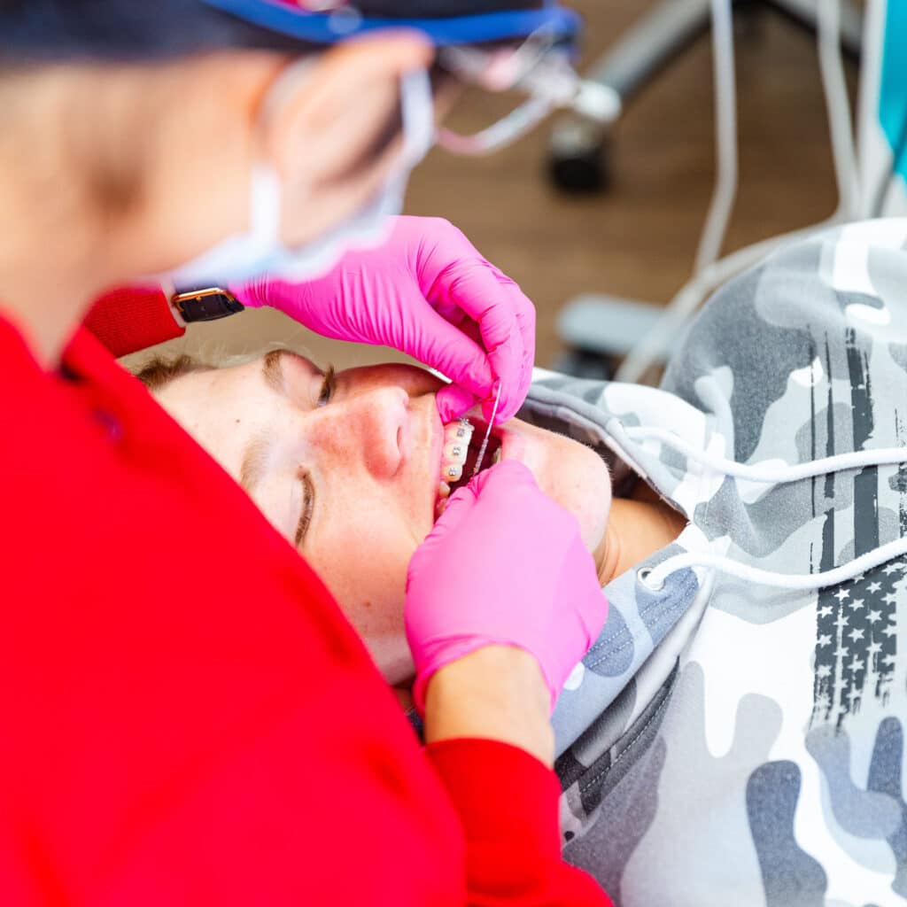 A woman is getting her teeth examined in the Hidden Valley orthodontics office.