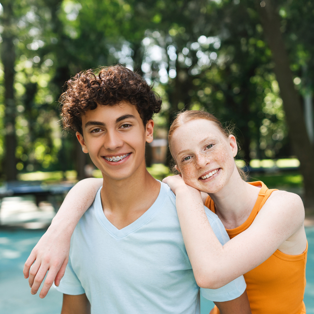 Smiling Teen Boy And Girl Wearing Braces