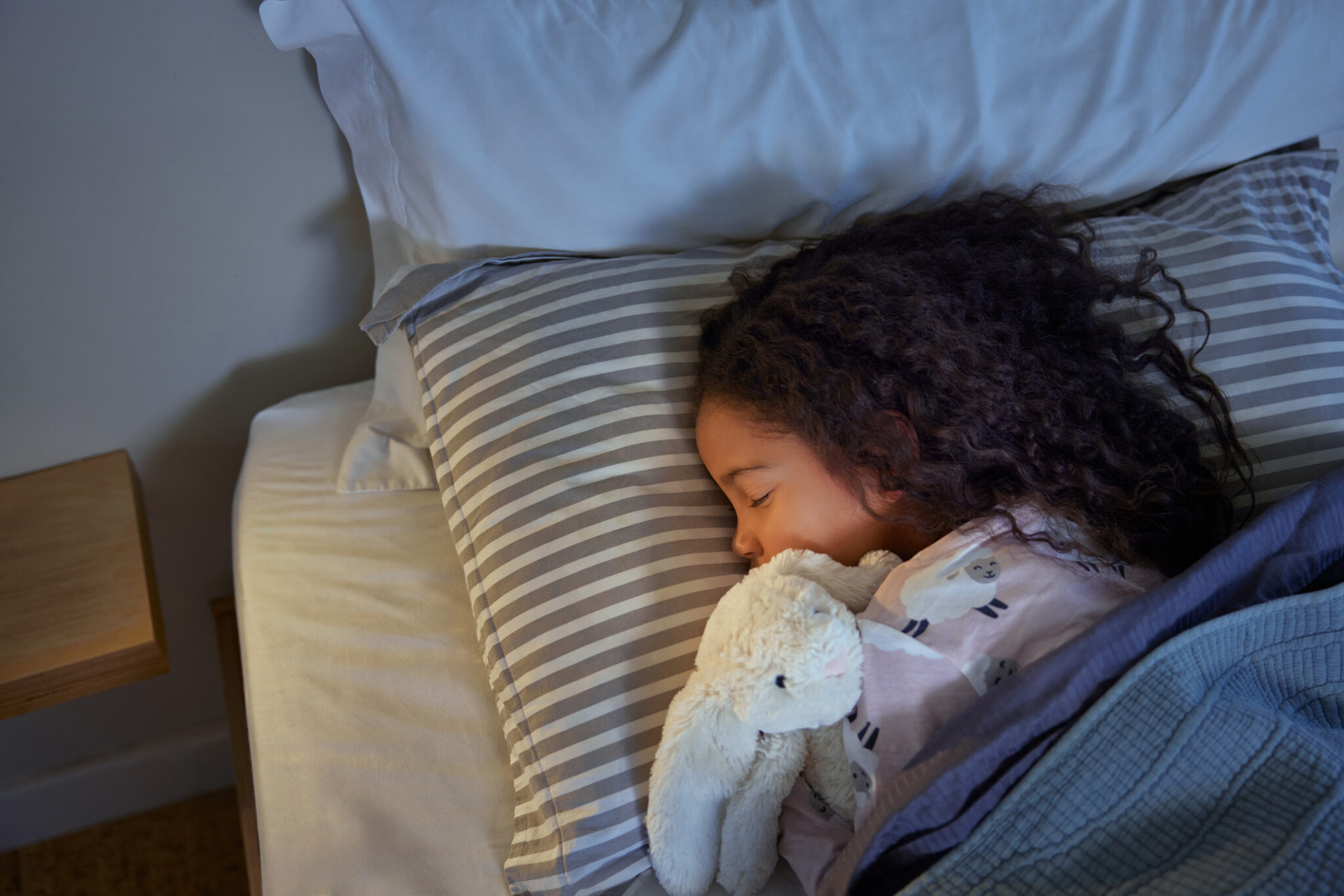 Lovely little girl sleeping peacefully during night