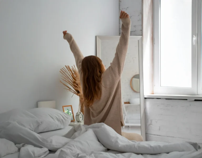 Woman waking up and stretching in the morning